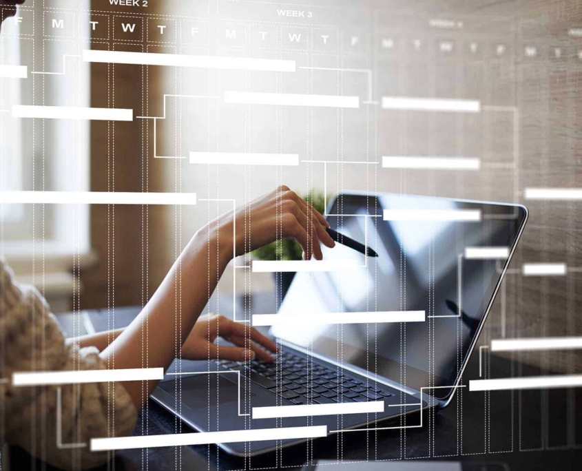 Side-view-of-worker-on-laptop-with-gantt-chart-concept