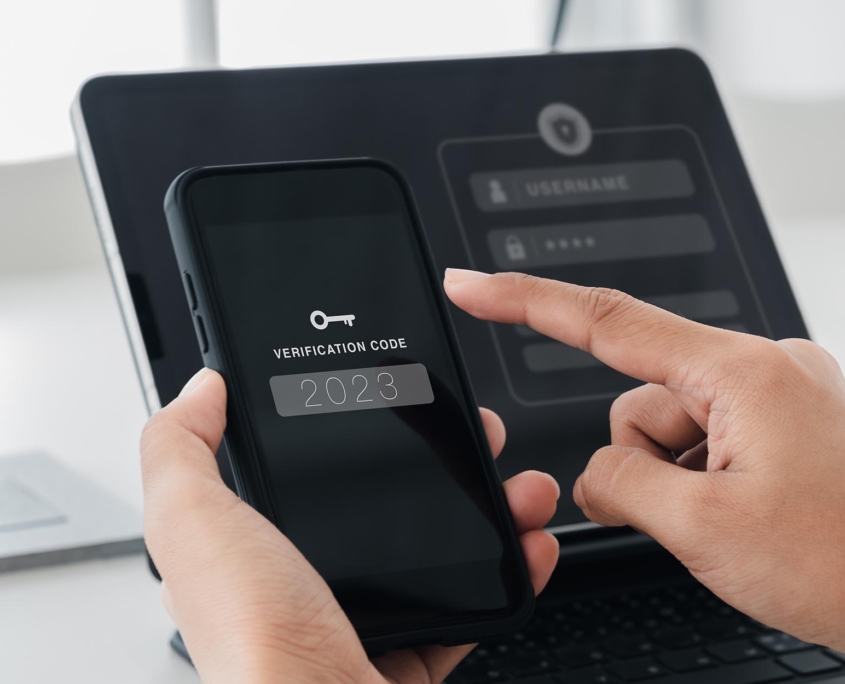 Person using two factor authentication on phone to log into work laptop