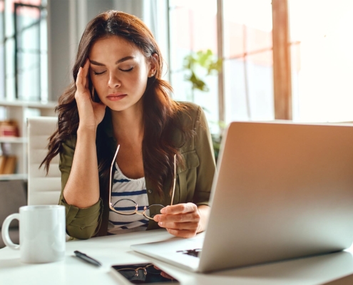 Worker in the office stressed at computer