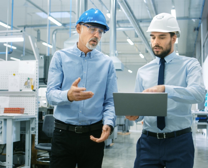 Two manufacturing workers talking