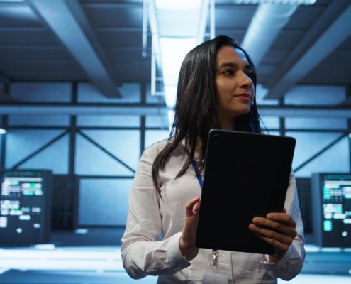 Tech professional checking on data center