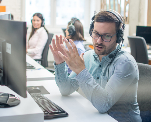 Professional at computer on call with customer
