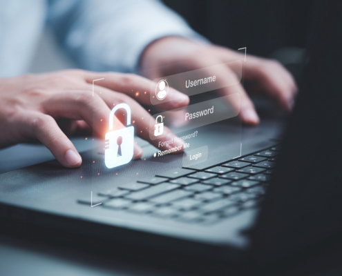 Businessman typing on keyboard laptop computer to input username and password
