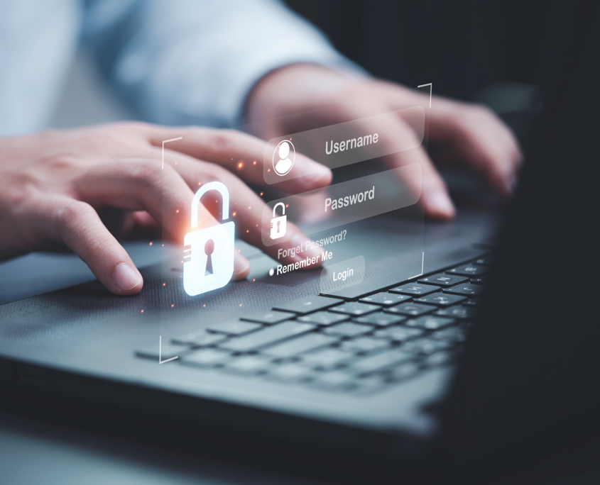 Businessman typing on keyboard laptop computer to input username and password